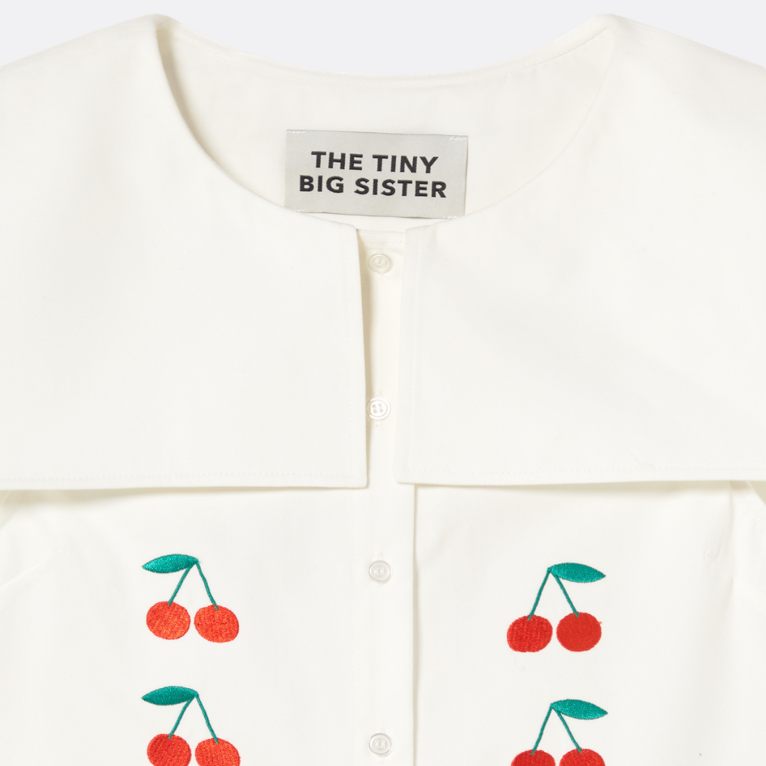 <PRODUCTTITLE> in White by Tiny Big Sister.