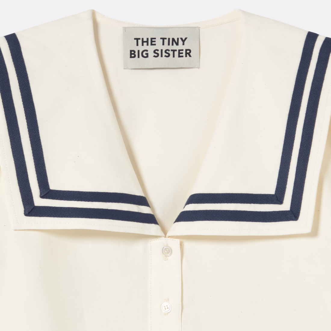 <PRODUCTTITLE> in White by Tiny Big Sister.