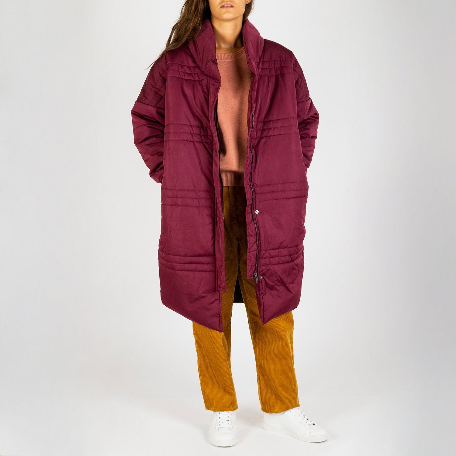 Burgundy colored long puffer jacket.