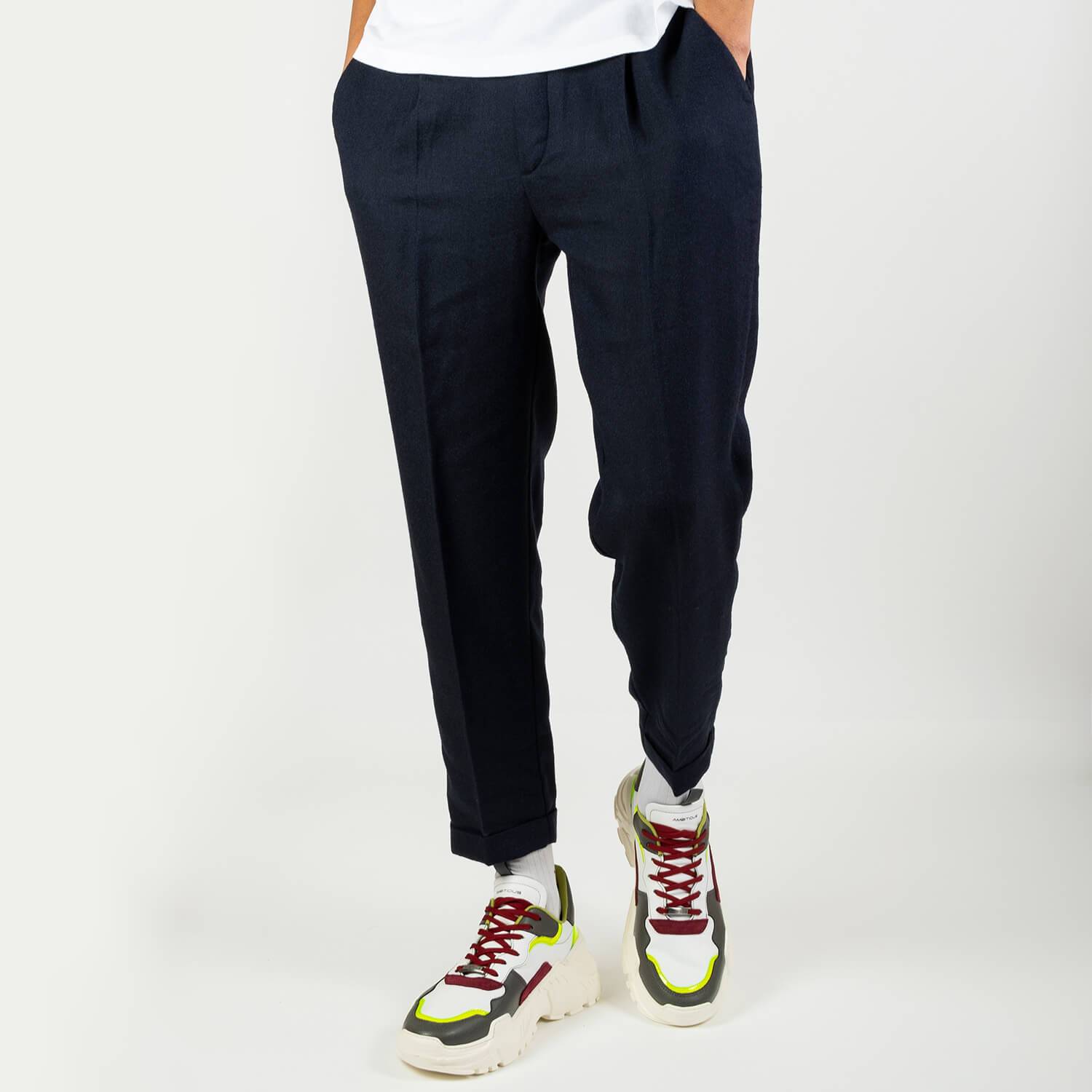 Navy blue slightly fitted 7/8 pants in a light seersucker with an elasticated belt on the back and thin pleats on the front.