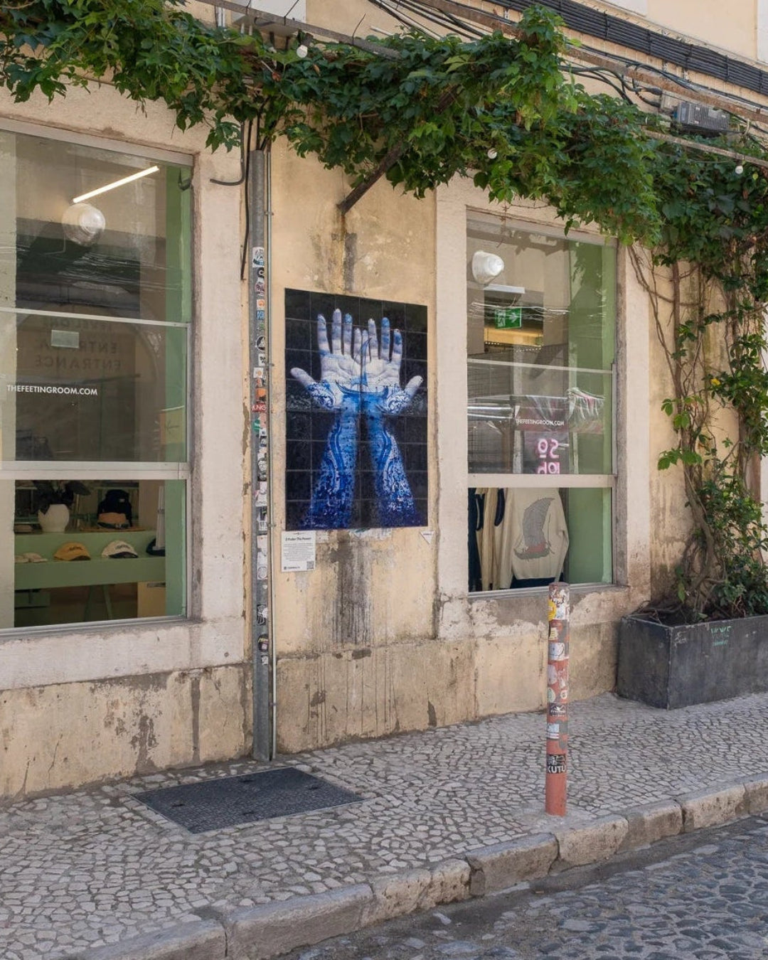 Industrial-style façade of The Feeting Room LX Factory concept store on Rua Rodrigues de Faria, Lisbon, with street art