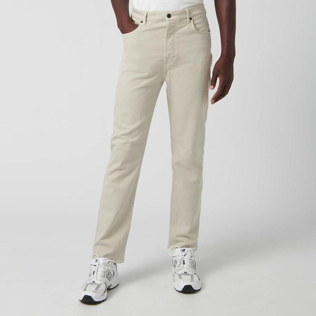 Relaxed fit beige denim trousers with five pockets.