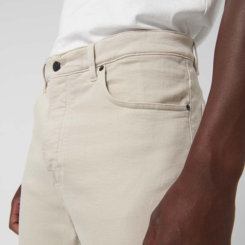 Relaxed fit beige denim trousers with five pockets.
