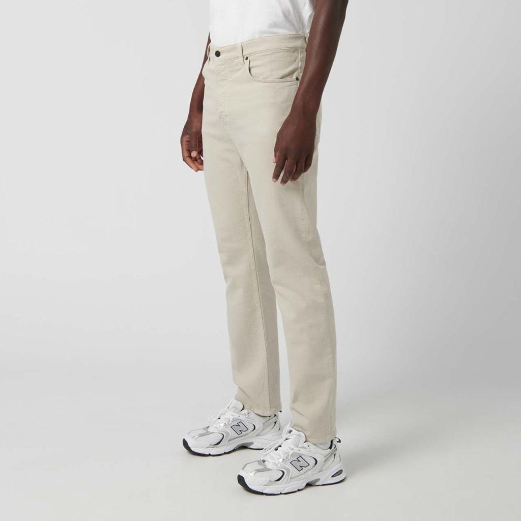 Relaxed fit beige denim trousers with five pockets.