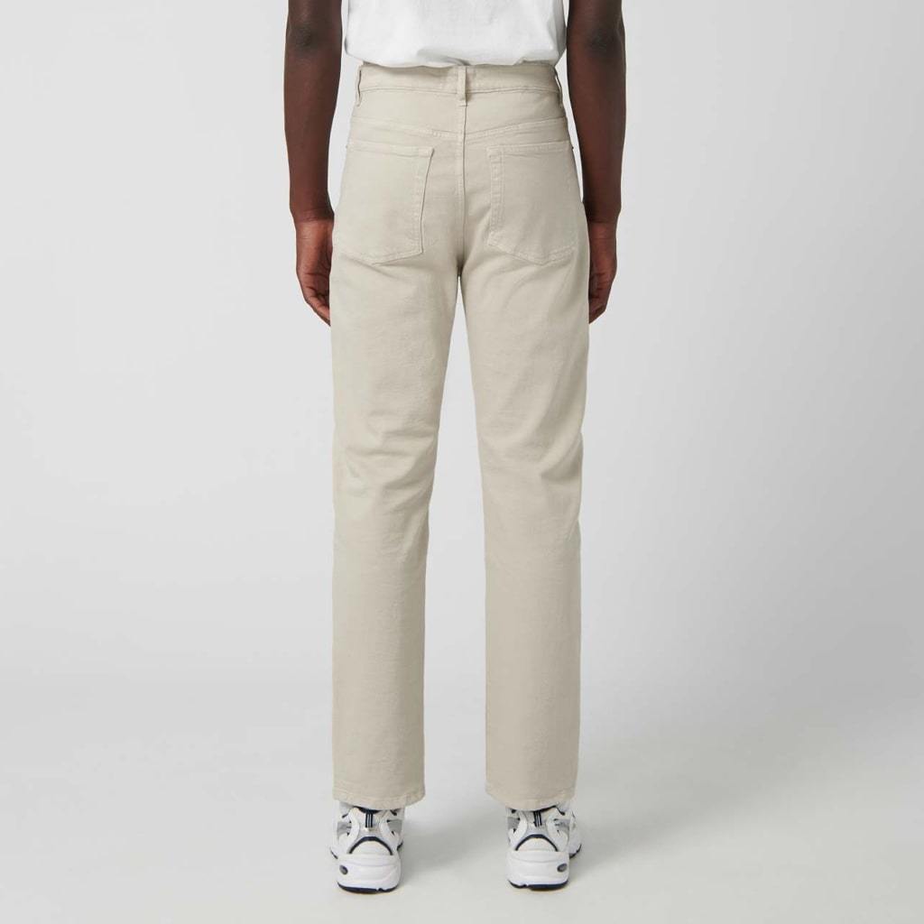 Relaxed fit beige denim trousers with five pockets.