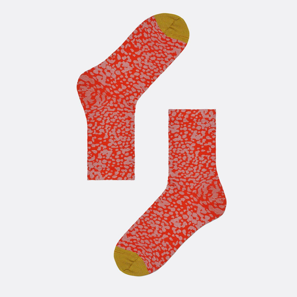 Red socks with dots pattern and yellow toe.