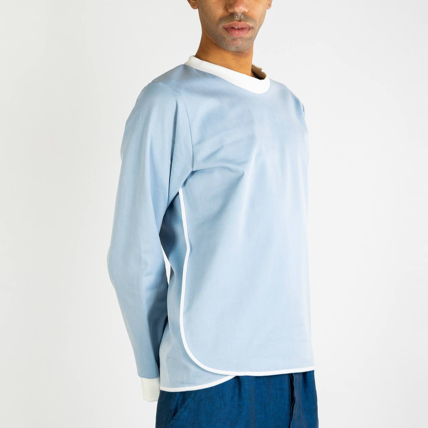 Light blue jumper with white collar and details.