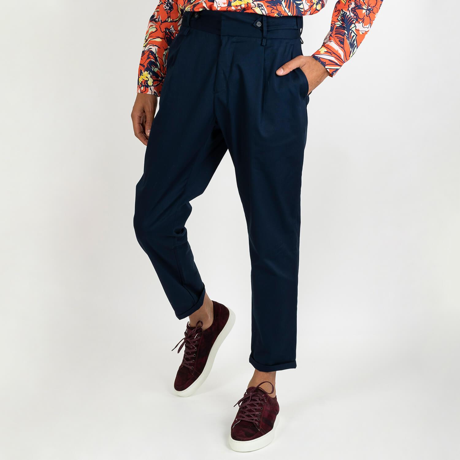 Navy blue cotton elasticated trousers featuring a waistband with belt loops, a straight leg and hook and zip fly.